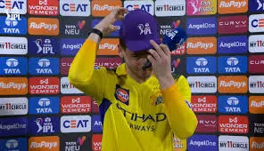 Noor Ahmad wearing a purple cap