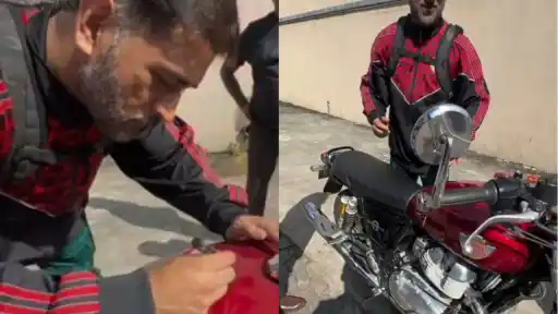 MS Dhoni signs autograph on fan’s bike in heartwarming gesture.