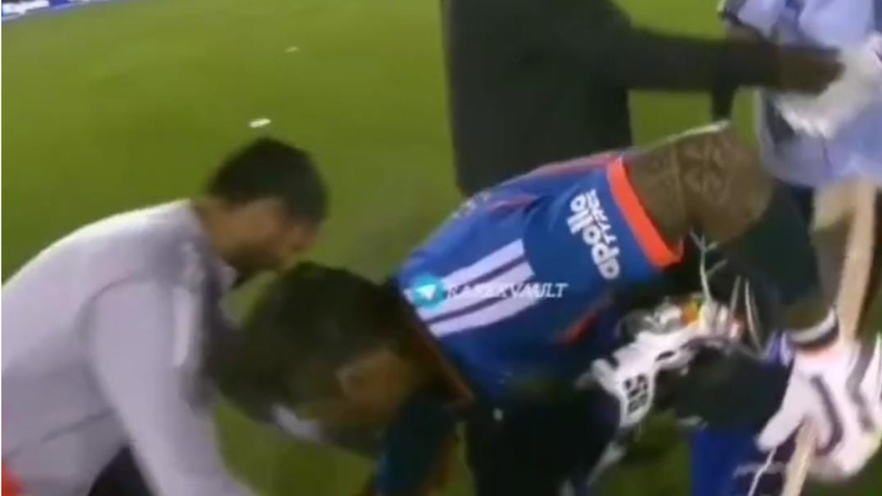 Suryakumar Yadav touches Raghu’s feet 