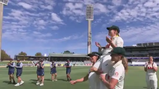 Australia players carry Alyssa Healy