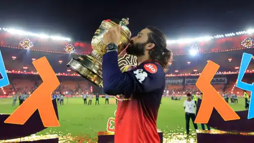 RCB captain Rajat Patidar lifting the IPL 2026 trophy at Narendra Modi Stadium Ahmedabad after defeating Gujarat Titans to win consecutive IPL championships in 2025 and 2026