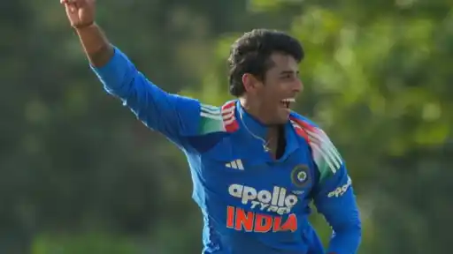 Indian cricketer celebrating with a raised fist while wearing the India jersey, reflecting the rise of a promising young talent