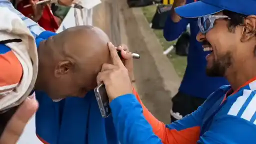 Ishan Kishan signing a fan's bald head after India's 3-0 series sweep against Zimbabwe