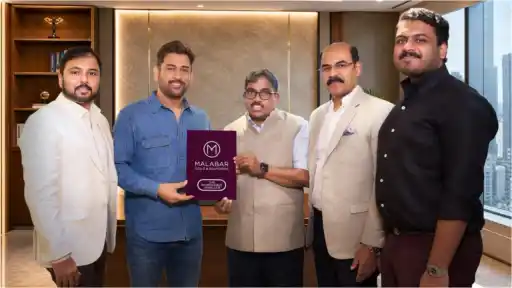 MS Dhoni poses with Malabar Gold & Diamonds officials as he is unveiled as the jewellery giant's new brand ambassador