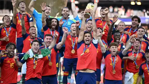 Spain squad celebrates with the FIFA World Cup 2026 trophy after their 1-0 win over Argentina in the final