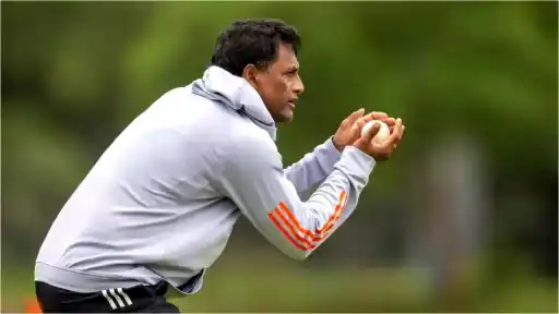 Coach in training gear catching a cricket ball during a fielding drill, tipped to replace T Dilip as India fielding coach