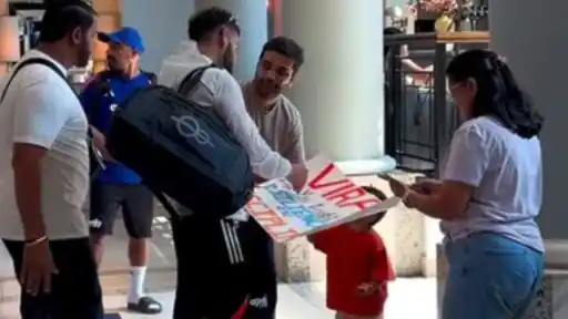 Virat Kohli signs a poster held by a young fan ahead of IND vs ENG 2nd ODI in Cardiff