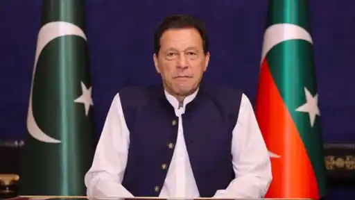 Imran Khan, former Pakistan cricket captain and prime minister, seated between Pakistan flags as the Supreme Court orders his move to hospital
