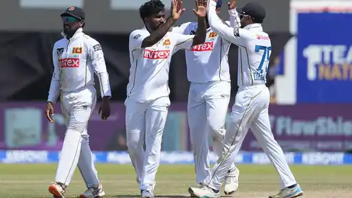 Sri Lanka players celebrating a wicket during a Test match, as the squad for the second Test vs India includes new call-ups Sahan Arachchige and Kamil Mishara
