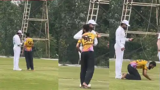 A fan performs sajdah on the ground after running onto the field to meet Pakistan batter Babar Azam at Abbottabad Stadium
