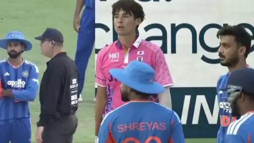 India player talking with the umpire and India players facing a Japan batter during the final over vs Japan