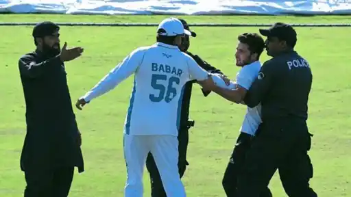 Babar Azam collides with a pitch invader during his President's Trophy return after a 7-year domestic absence