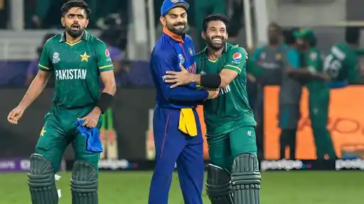 Virat Kohli shares a light moment with Pakistan players on the field during an ICC tournament