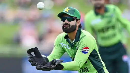 Mohammad Rizwan taking a catch during a match amid online betting accusations and court proceedings