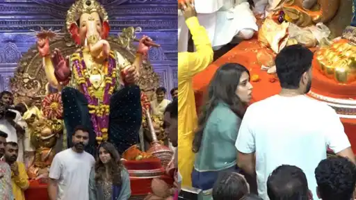 Rohit Sharma and wife Ritika Sajdeh standing before the Lalbaugcha Raja idol in Mumbai, seeking blessings