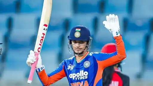 Smriti Mandhana raises her bat after scoring a record-breaking century to become the leading century-maker in women's cricket at Asia Cup 2026