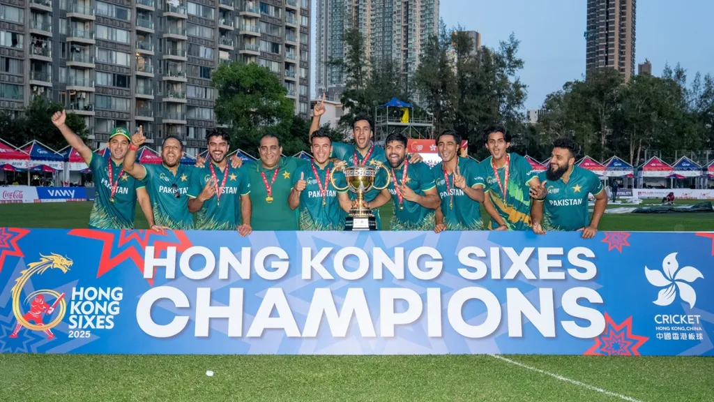 Pakistan players in green kit and medals pose with the trophy behind a Hong Kong Sixes 2025 Champions banner, as Pakistan announce their squad for Hong Kong Sixes 2026 with Abbas Afridi as captain