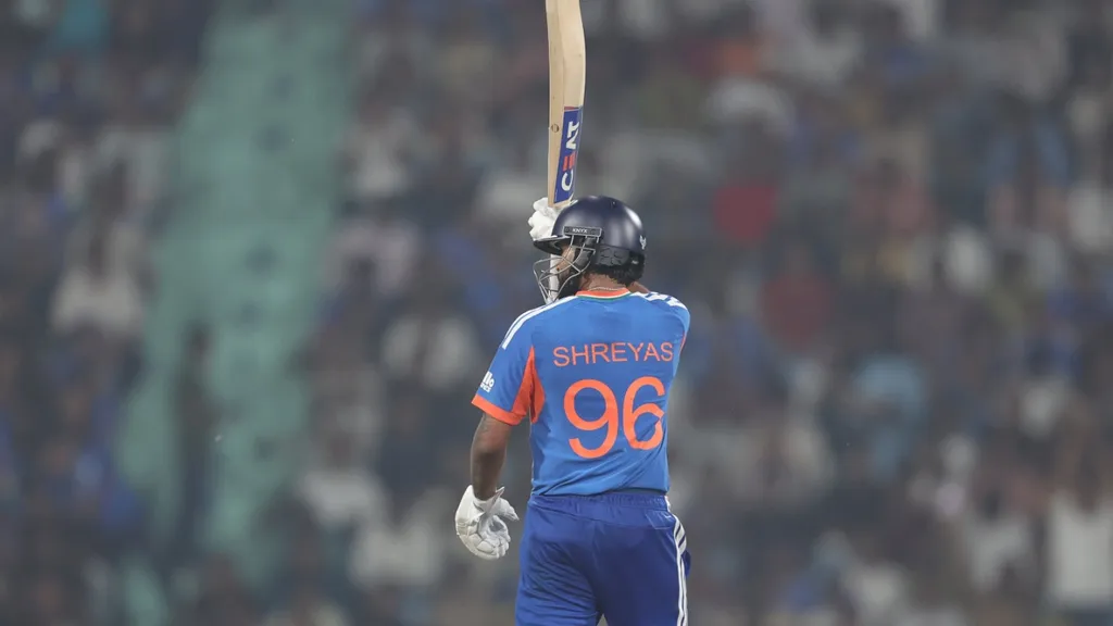 Shreyas Iyer, wearing the India jersey number 96, raises his bat to the crowd after scoring his maiden T20I century in 42 balls against West Indies