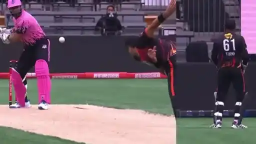Batter in pink kit and pads looks up at a high bouncer as the bowler in black and orange follows through, beside a wicketkeeper in a TARIQ 61 shirt in the Canada Super 60 2026 semi-final