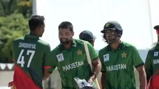 Smiling Pakistan batters in green kit walk off after beating Bangladesh in the Asian Games 2026 semifinal, as a Bangladesh player congratulates them