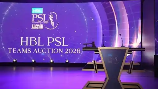 Empty stage with a podium, gavel and two microphones in front of a purple screen reading HBL PSL Teams Auction 2026 with the PSL Auction logo