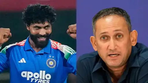 Ravindra Jadeja in a blue jersey raising his fists beside a man in a navy shirt speaking at a press event, as a cryptic reply to BCCI's selector vacancy post makes headlines