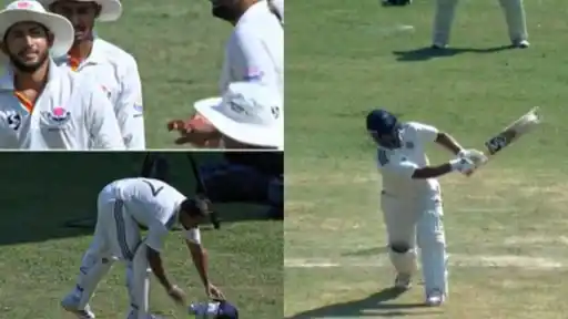 Rest of India batter in whites playing a shot, a batter bending down beside his helmet