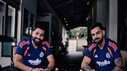 Rohit Sharma and Virat Kohli, in navy India training shirts, sit smiling at a table in their viral collaboration video ahead of the ODI World Cup 2027