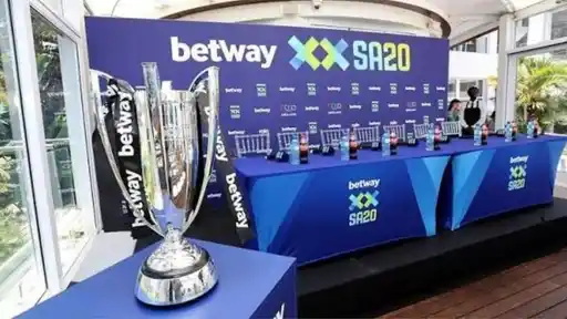 SA20 trophy with Betway ribbons beside the auction stage and press table, as the SA20 2027 auction sold players list and updated squads are revealed