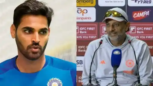 Bhuvneshwar Kumar in India's blue jersey beside batting coach Sitanshu Kotak speaking at a press conference, as Kotak explains Bhuvneshwar's T20I recall