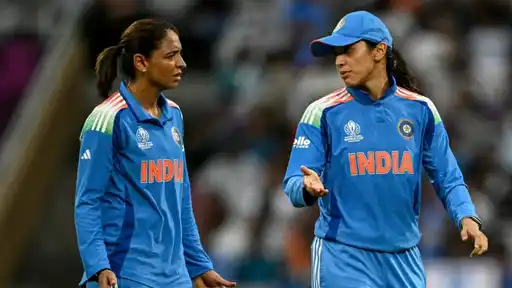 Smriti Mandhana talks with a teammate on the field after being named India captain for the T20I and ODI series vs Zimbabwe
